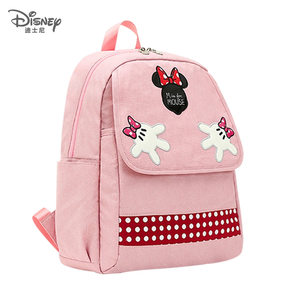 Una mochila rosa Minnie Mouse con un arco en el frente