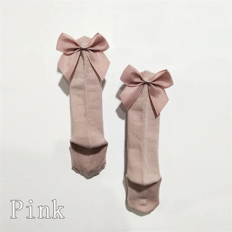 Dos calcetines rosados ​​colgando en una pared