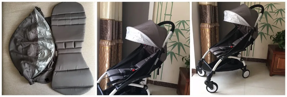 Un cochecito con la capota parcialmente plegada. La capota está diseñada para proporcionar sombra y protección al niño sentado en el cochecito. El cochecito parece tener un diseño moderno y compacto, probablemente destinado a uso urbano o de viaje.