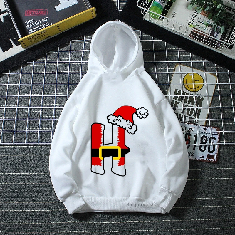Una sudadera con capucha blanca con un diseño gráfico en el frente. El diseño presenta una representación estilizada de un personaje que parece ser una combinación de un árbol de Navidad y una persona, con el árbol sirviendo como cuerpo y una cara dibujada en él.