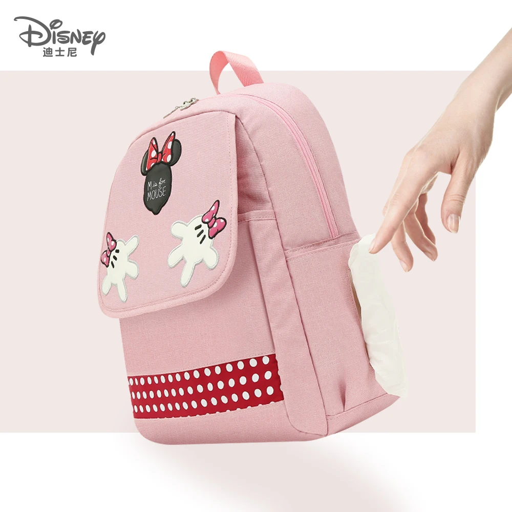 Una mochila rosa Minnie Mouse con un arco en el frente