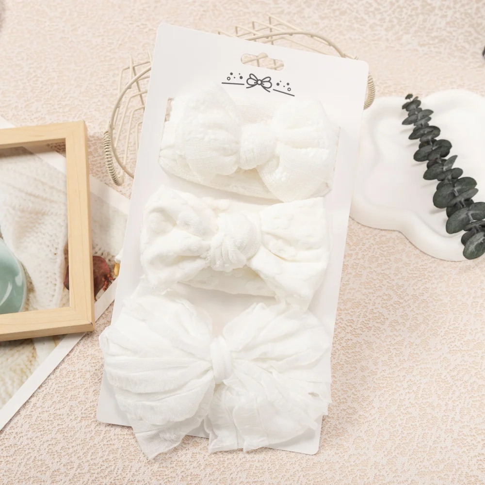 Diadema bebé blanca con lazo elástica de nailon para niña elegante