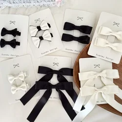 Clips de pelo infantil con lazo blanco y negro