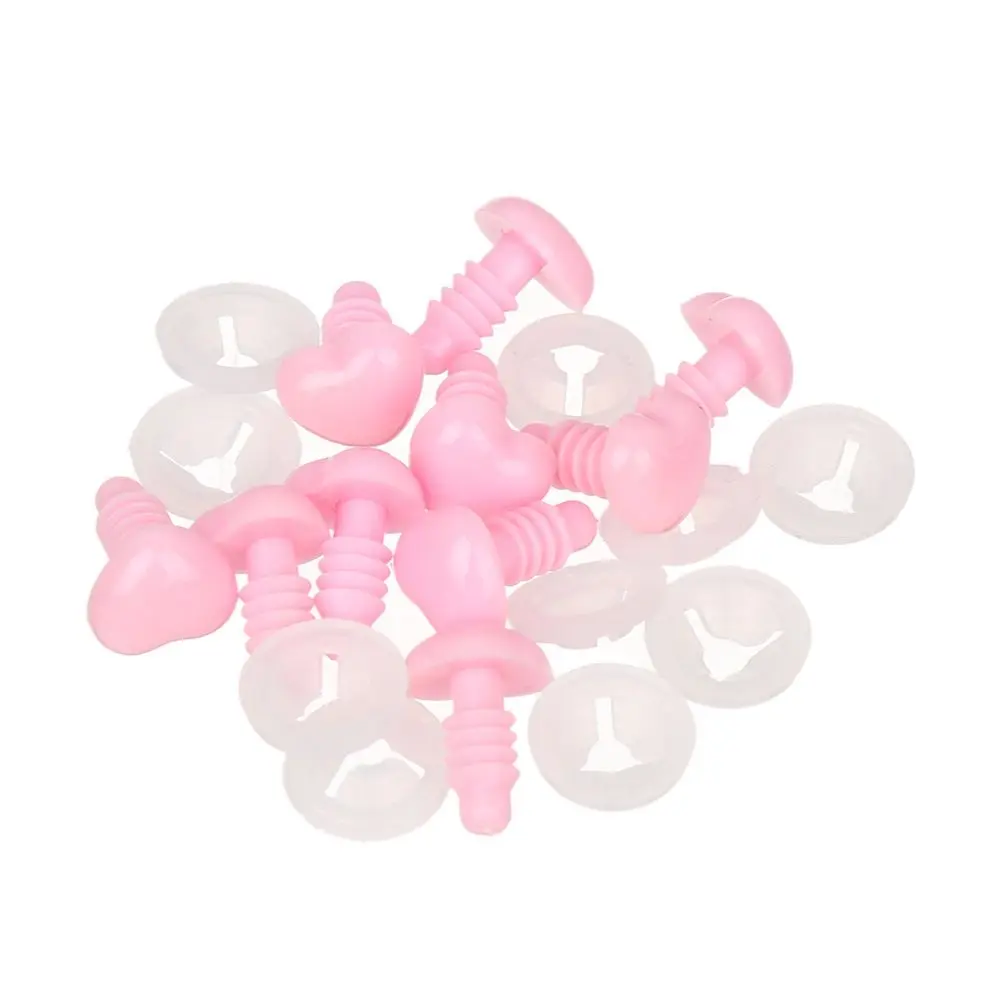 Un montón de botones rosados ​​con tornillos en ellos