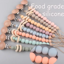 Sujetachupetes de silicona y madera natural para bebé