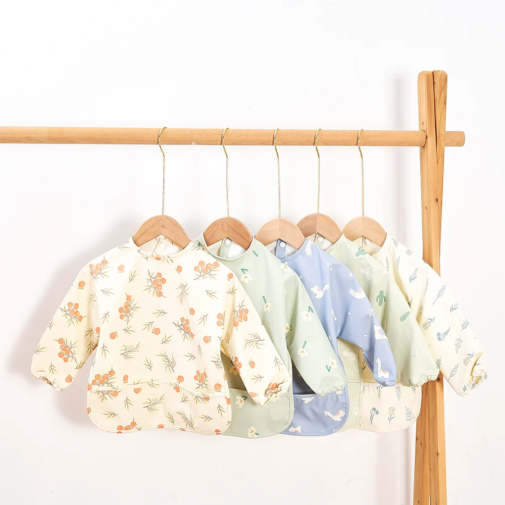 HappyFlute-mono danés de tela PU de alta calidad, nuevo estilo, bonito, impermeable, de manga larga, con broche, bolsillo grande, babero de alimentación sin suciedad