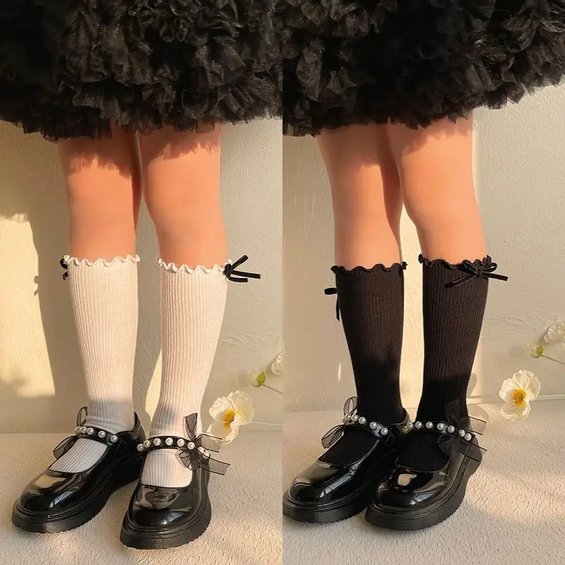 1 par de calcetines hasta la pantorrilla para niña, calcetines hasta la rodilla con volantes estilo lazo de Color blanco y negro para niños pequeños, calcetines a rayas de algodón suave
