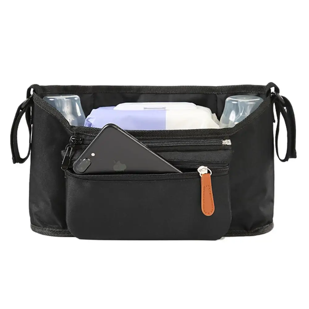 Una bolsa negra con varios artículos en su interior. Parece ser una pequeña bolsa con cremallera que se puede usar para llevar pertenencias personales. En el interior hay un teléfono inteligente, unas gafas de sol y lo que parece una pequeña botella o recipiente.