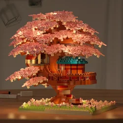 Sakura cerezo con luz y casa árbol bloques de construcción