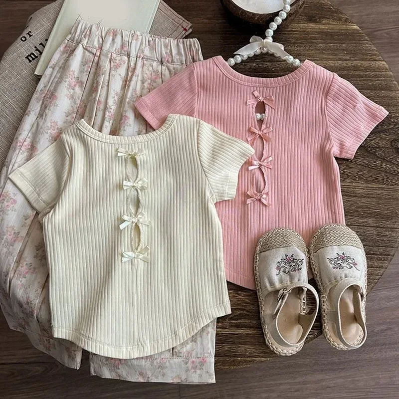 Camisetas de manga corta para niñas, novedad de verano 2021, camisetas de Edición coreana para niñas, pantalones cortos de princesa con lazo hueco en la espalda a la moda