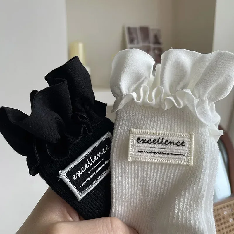1 par de calcetines sencillos a la moda Ins para niños, calcetines hasta la pantorrilla para niña, calcetines con volantes de Color blanco y negro para niños, calcetines escolares de primavera de algodón suave