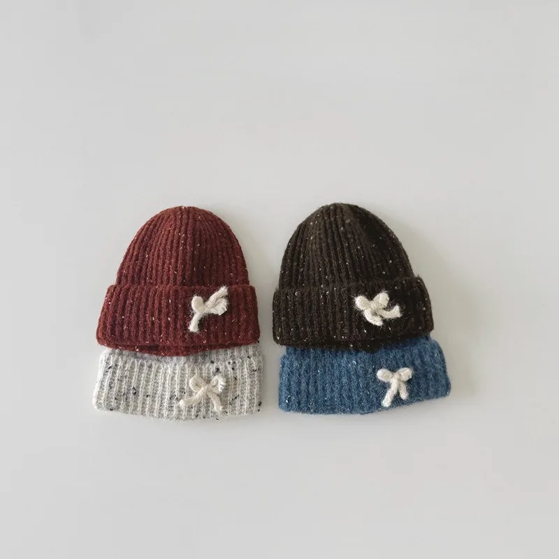 Gorro de punto con lazo para bebé de estilo coreano, bonito gorro de invierno para niñas, gorro de ganchillo suave y cálido, gorro de moda para niños pequeños con orejeras