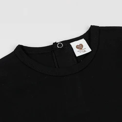 Conjunto bebé algodón y elastán negro, cuello redondo