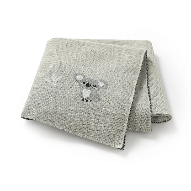 Manta para bebé gris en ambiente de dormitorio
