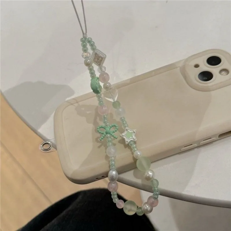Cadena para móvil niña con lazo de estrella y luna verde – Antipérdida