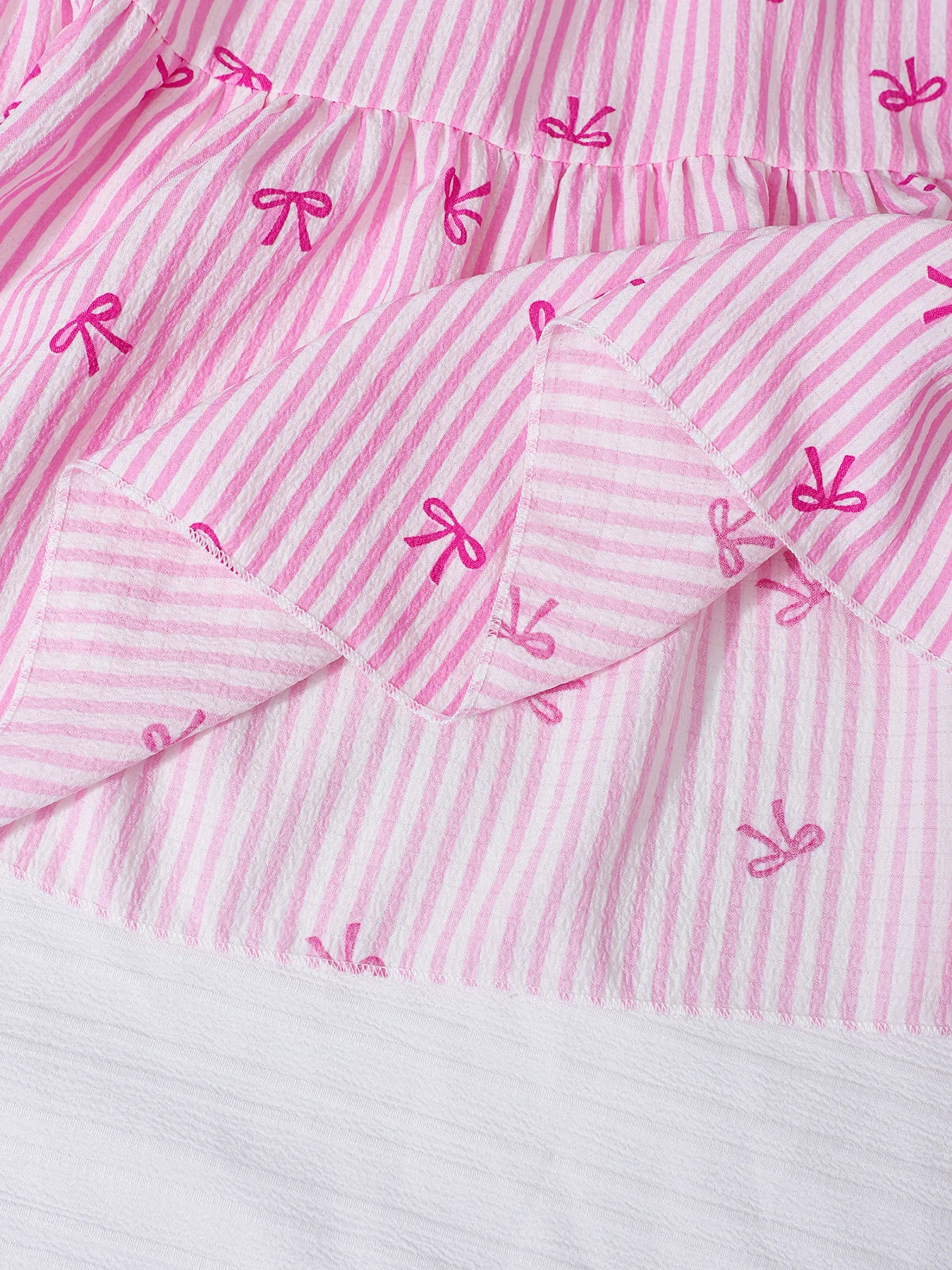 Falda midi de rayas verticales rosas con lazos pequeños para niño