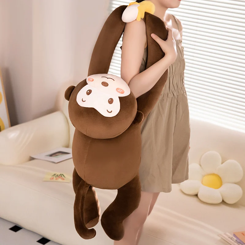 Peluche de mono tumbado estilo plátano