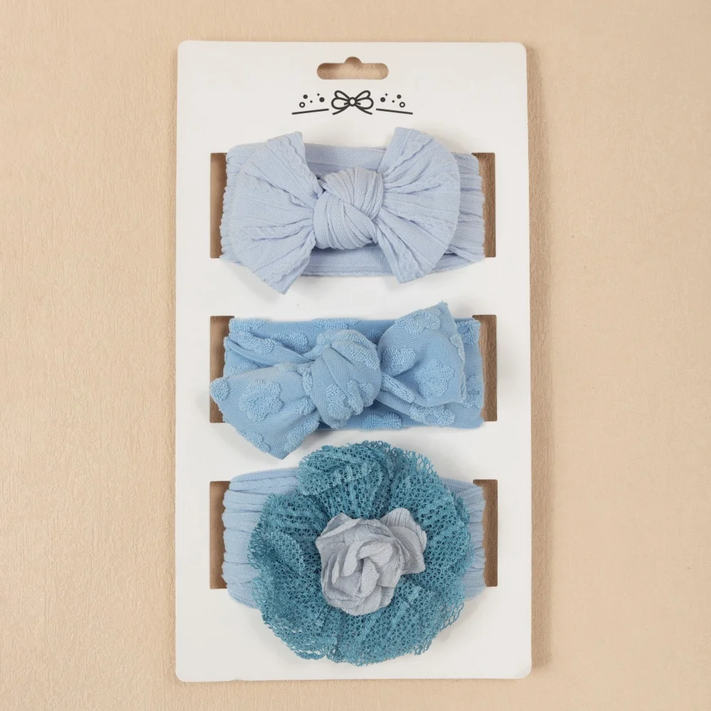 Diadema azul para bebé con lazo de flores