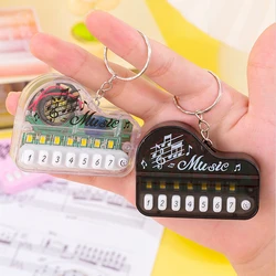 Piano electrónico infantil luminoso con llavero musical y colgante