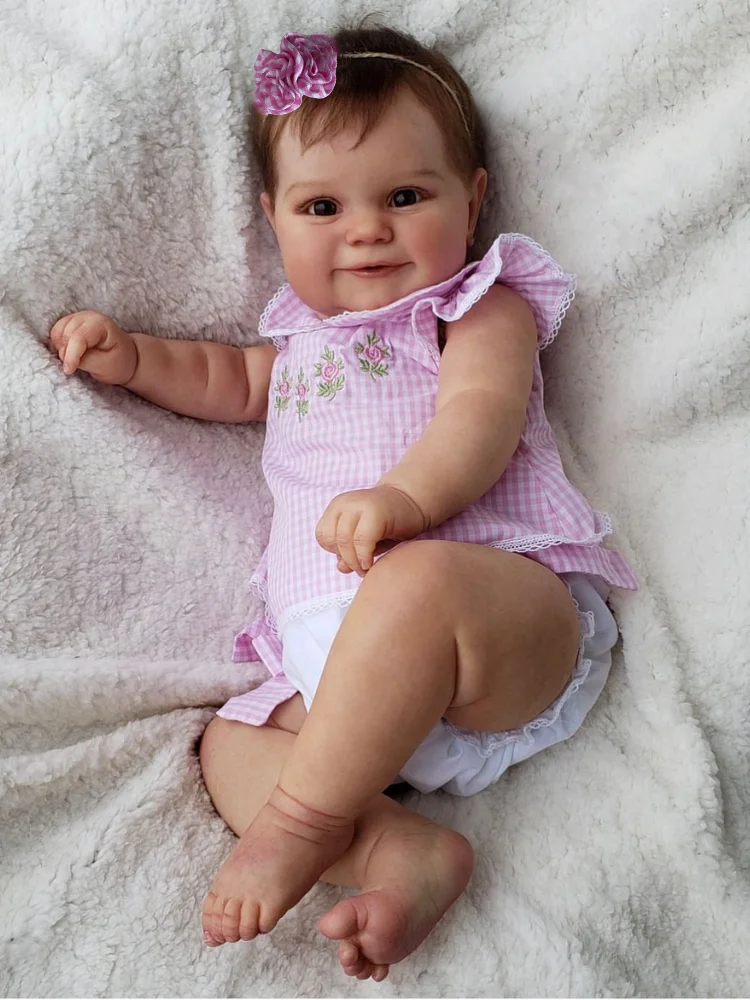 Muñeca Reborn con cuerpo de vinilo en posición sentada