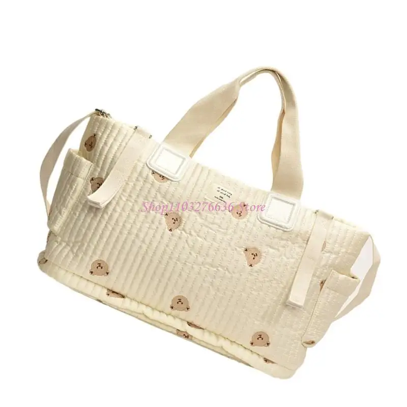 Bolso de maternidad con patrón bordado y múltiples compartimentos