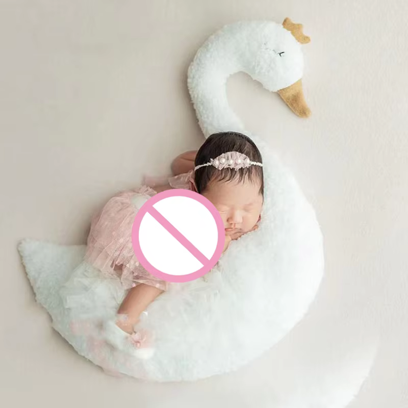 Cojín de cisne utilizado como elemento decorativo en cuarto de bebé