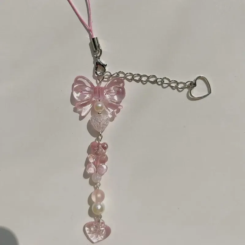 Abalorio para teléfono con lazo plateado rosa y colgante corazón