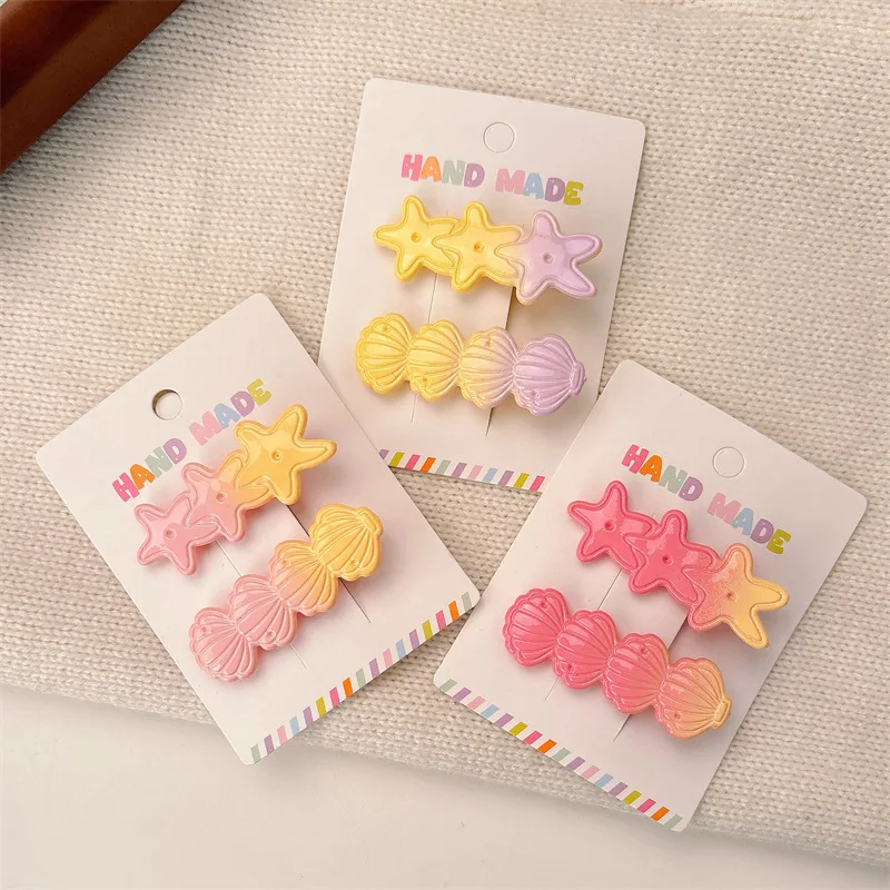 Pinza de pelo infantil con concha y estrella de mar