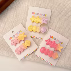 Pinza de pelo infantil con concha y estrella de mar