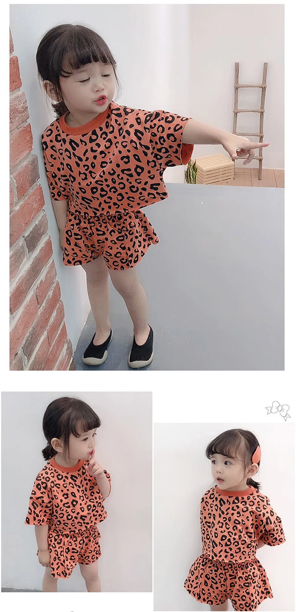 Niño pequeño modelando el conjunto de leopardo en exterior