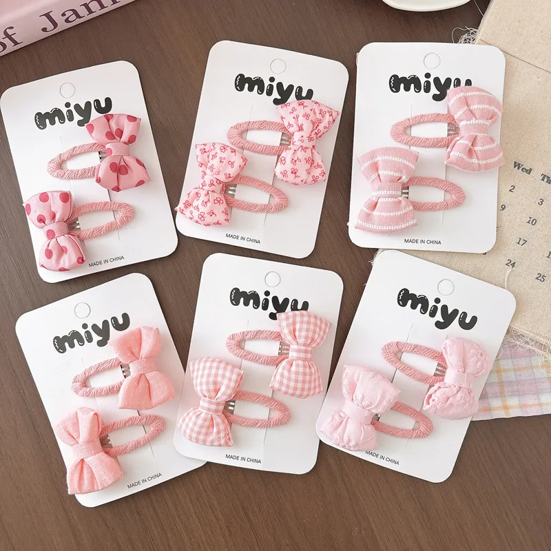 Pinzas para el pelo de niña con lazo rosa y lunares de tela