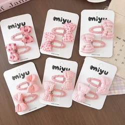 Pinzas para el pelo de niña con lazo rosa y lunares de tela