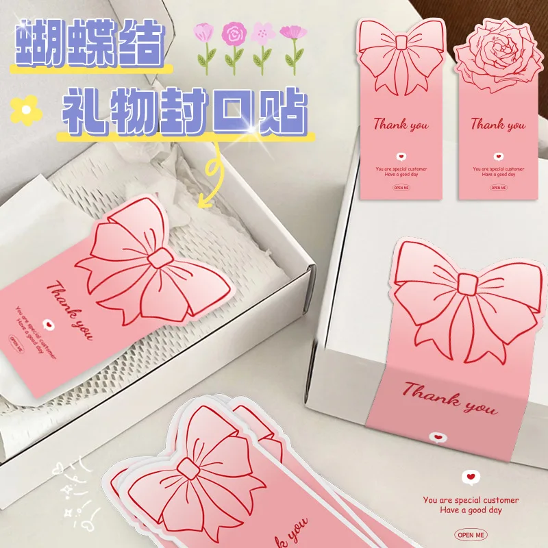 Pegatinas rosas de lazo sobre caja de regalo