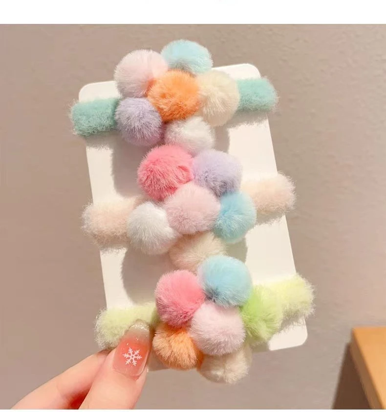 Diadema infantil con lazos y flores de peluche