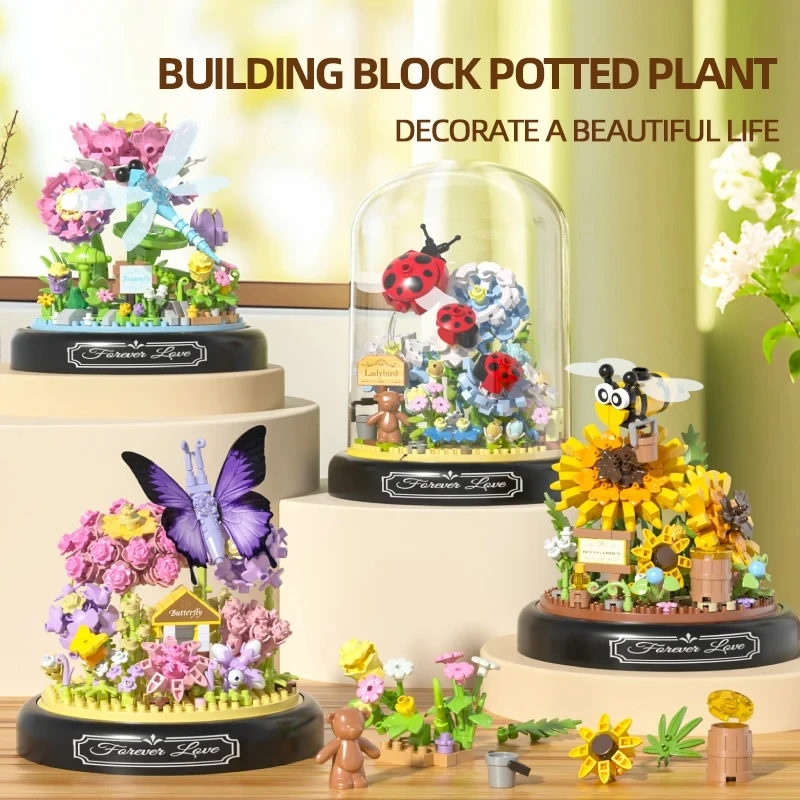 Bloques de construcción en maceta con insectos, flores y abeja