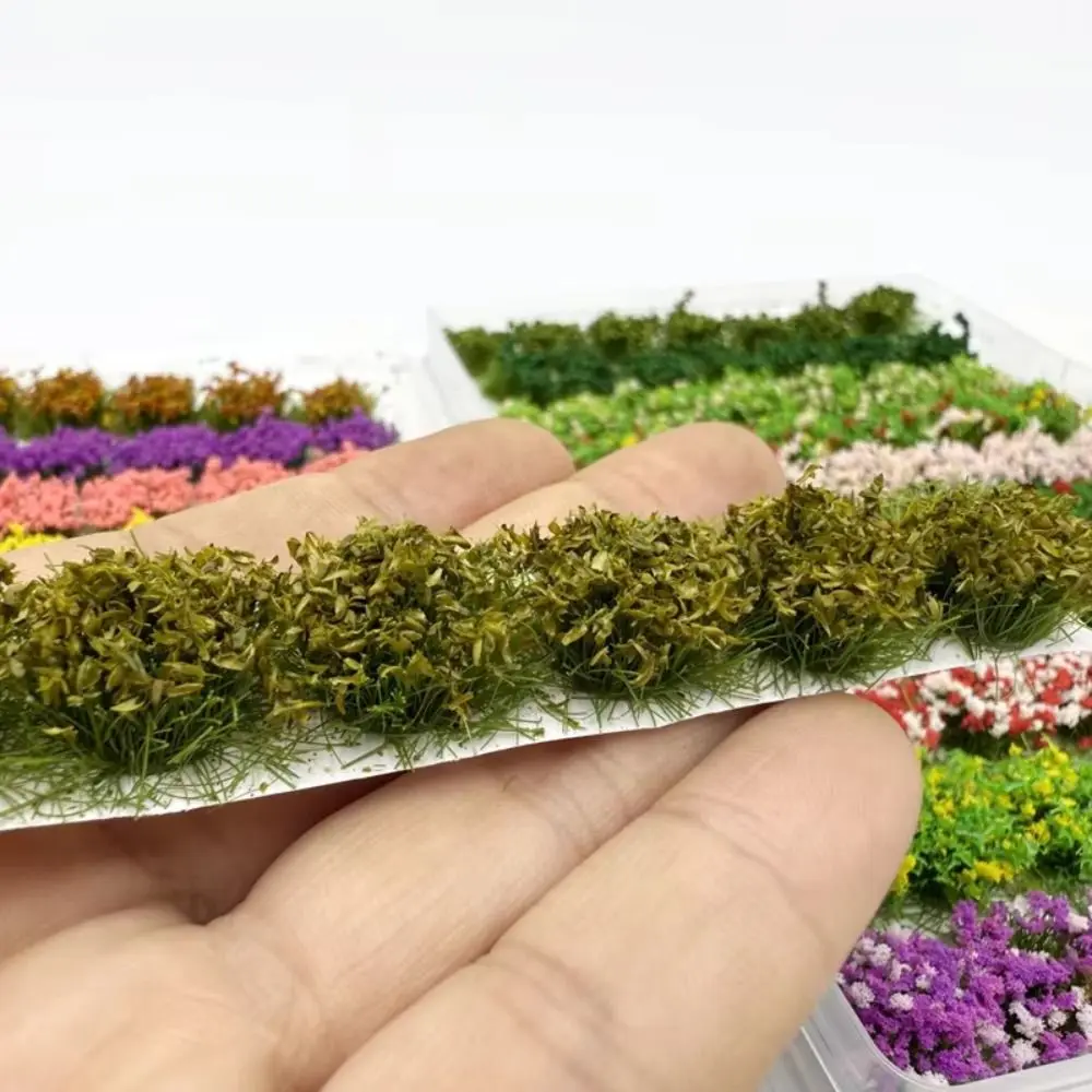 Escena de modelismo con flores en miniatura