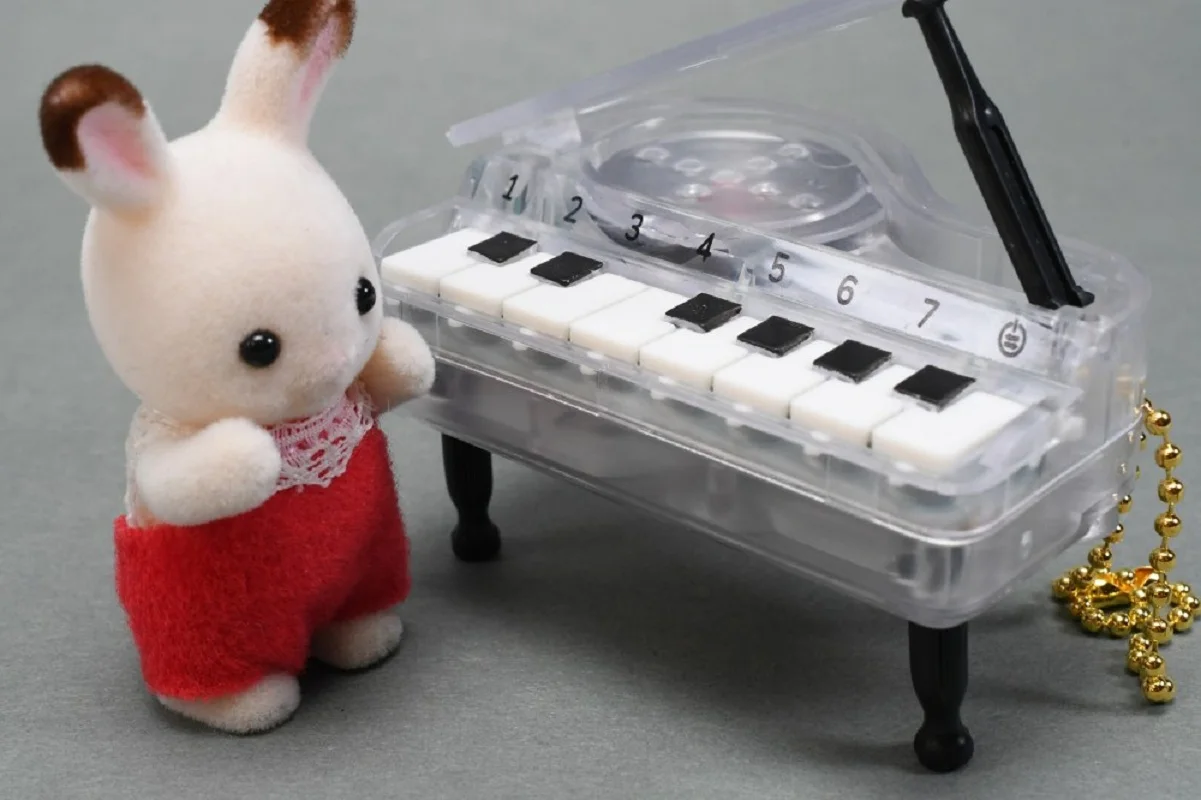 Piano de cápsula en acabado blanco y transparente con cadena de bolas