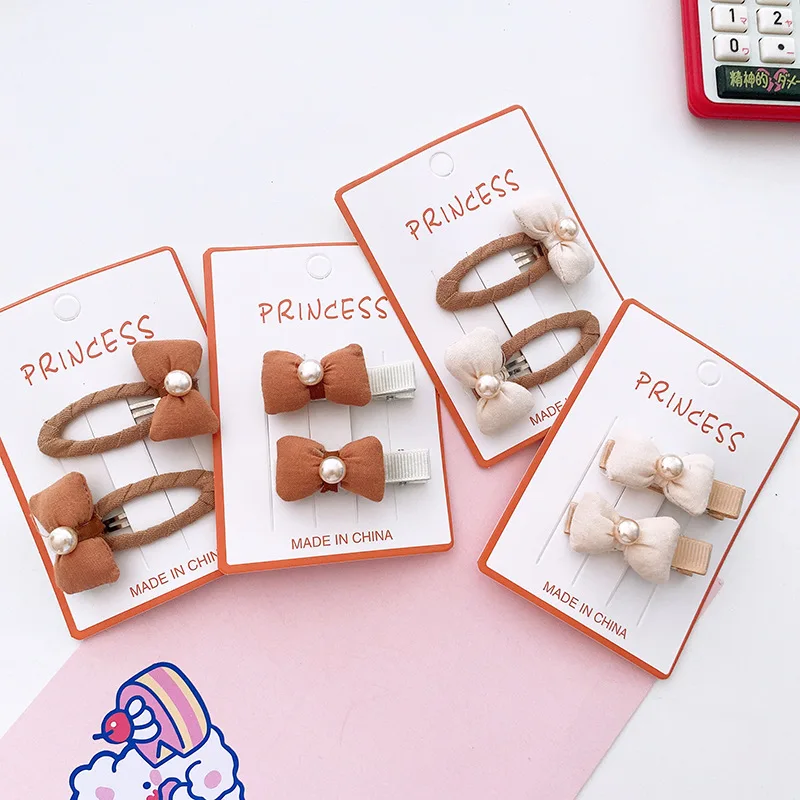 Set de dos clips infantiles con lazo