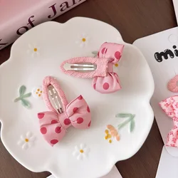Pinzas para el pelo de niña con lazo rosa y lunares de tela