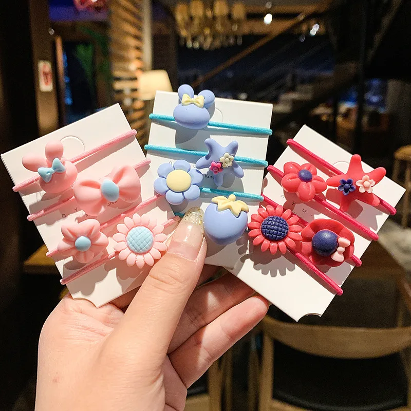 gomas de colores para el cabello infantil en tonosrosa, azul y verde