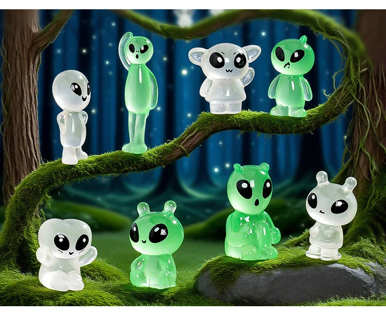 Figuras de gatos alienígenas verdes en escritorio