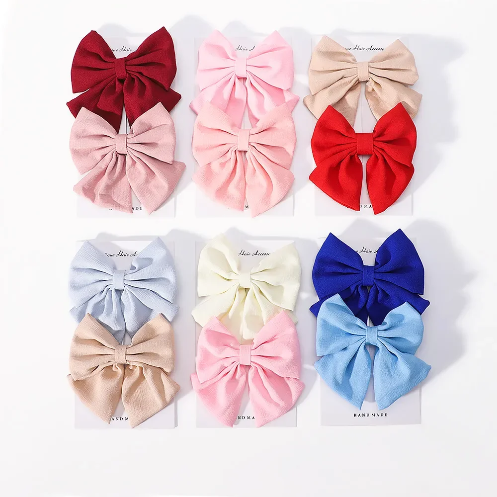 Clips de pelo infantiles en tonos rosa y azul con lazo sólido