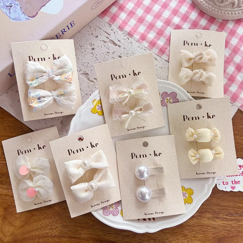 Pinzas para cabello con lazo de perlas color crema