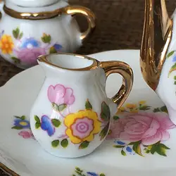 Juego de té en miniatura con tetera floral, plato y jarra